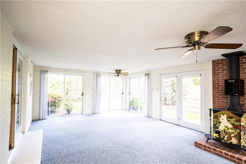 58 Bellview Circle McKees Rocks, PA 15136 - Photo 8 of 25 2 ceiling fans and sliding glass door exits on three sides plus french doors.
