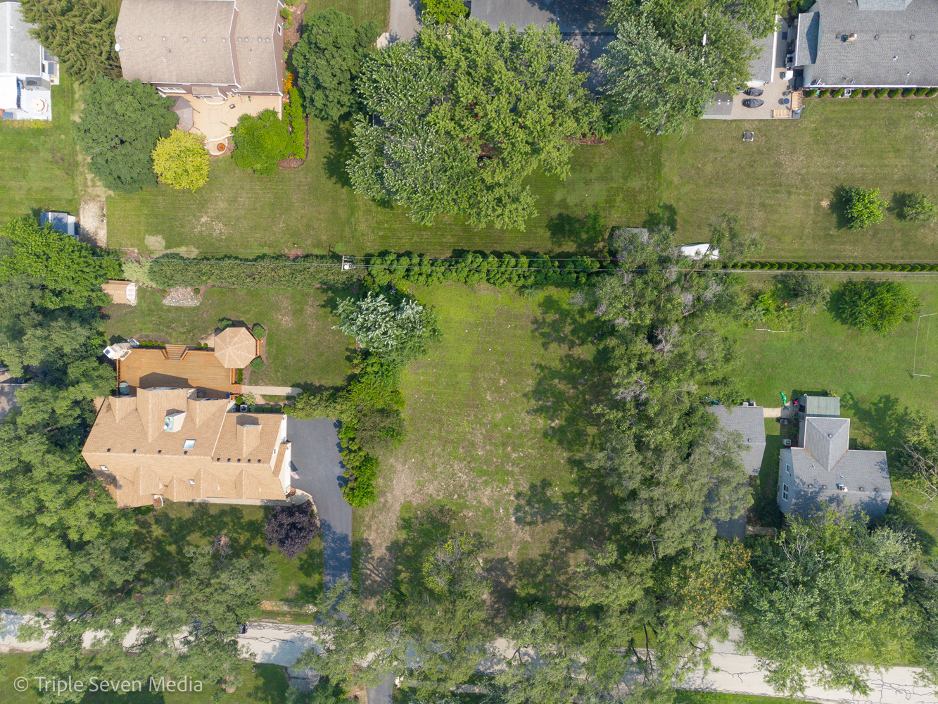 an aerial view of a house with a yard basket ball court and outdoor seating
