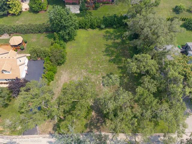 an aerial view of a houses with yard