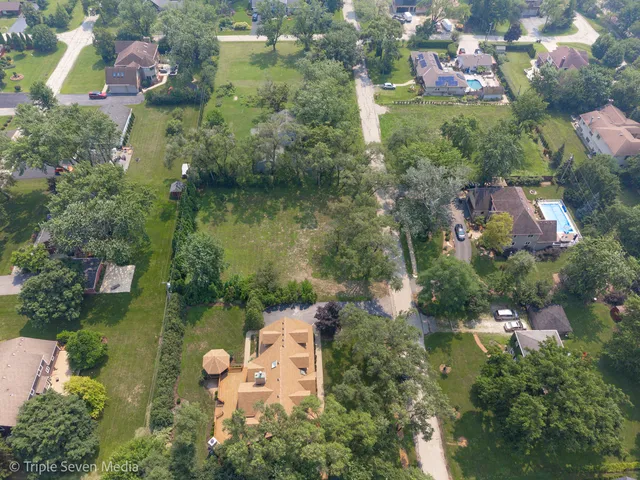 an aerial view of residential house with outdoor space and swimming pool