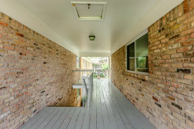 a view of a balcony with wooden floor