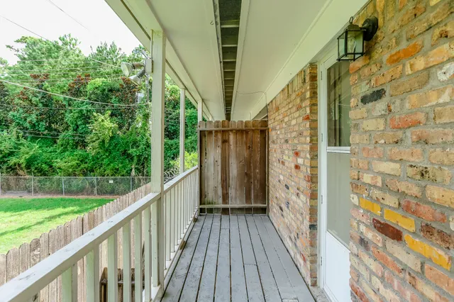a view of a chair and table in backyard of the house