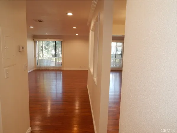 a view of hallway with wooden floor