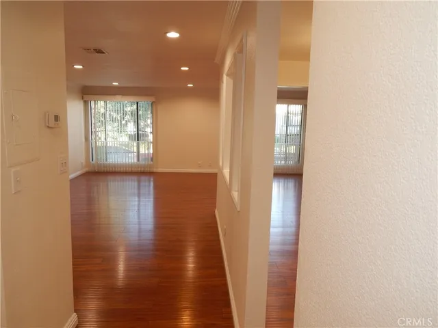 a view of hallway with wooden floor