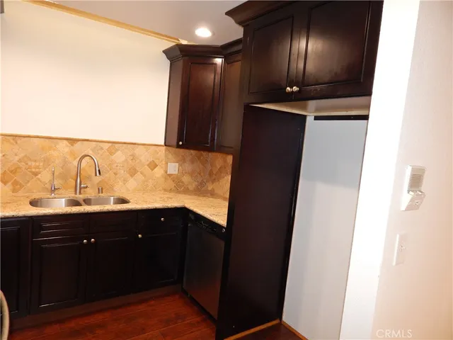 a kitchen with granite countertop cabinets and stove