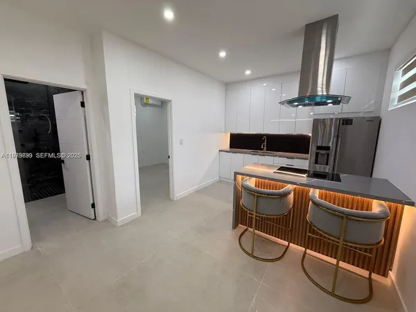 a room with table chairs and white walls