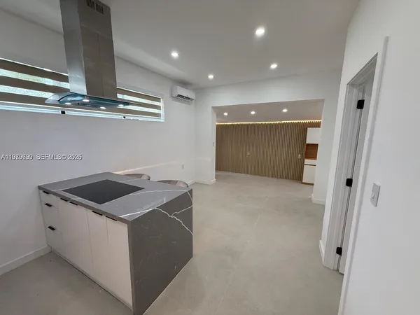 a kitchen with a sink and chandelier