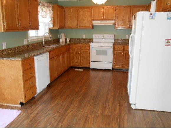 639 Wendy Graham, NC 27253 - Photo 2 of 21 a kitchen with a white cabinets and white appliances