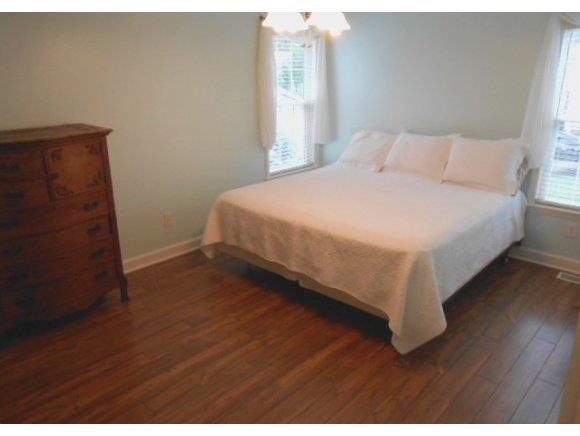 639 Wendy Graham, NC 27253 - Photo 6 of 21 a bedroom with a bed and wooden floor