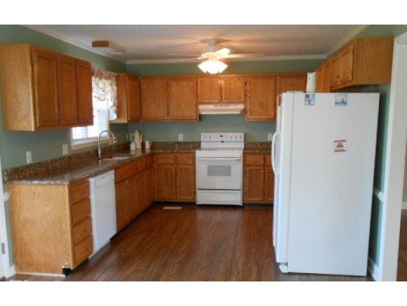 639 Wendy Graham, NC 27253 - Photo 8 of 21 a kitchen with a refrigerator a sink dishwasher and a stove with wooden floor