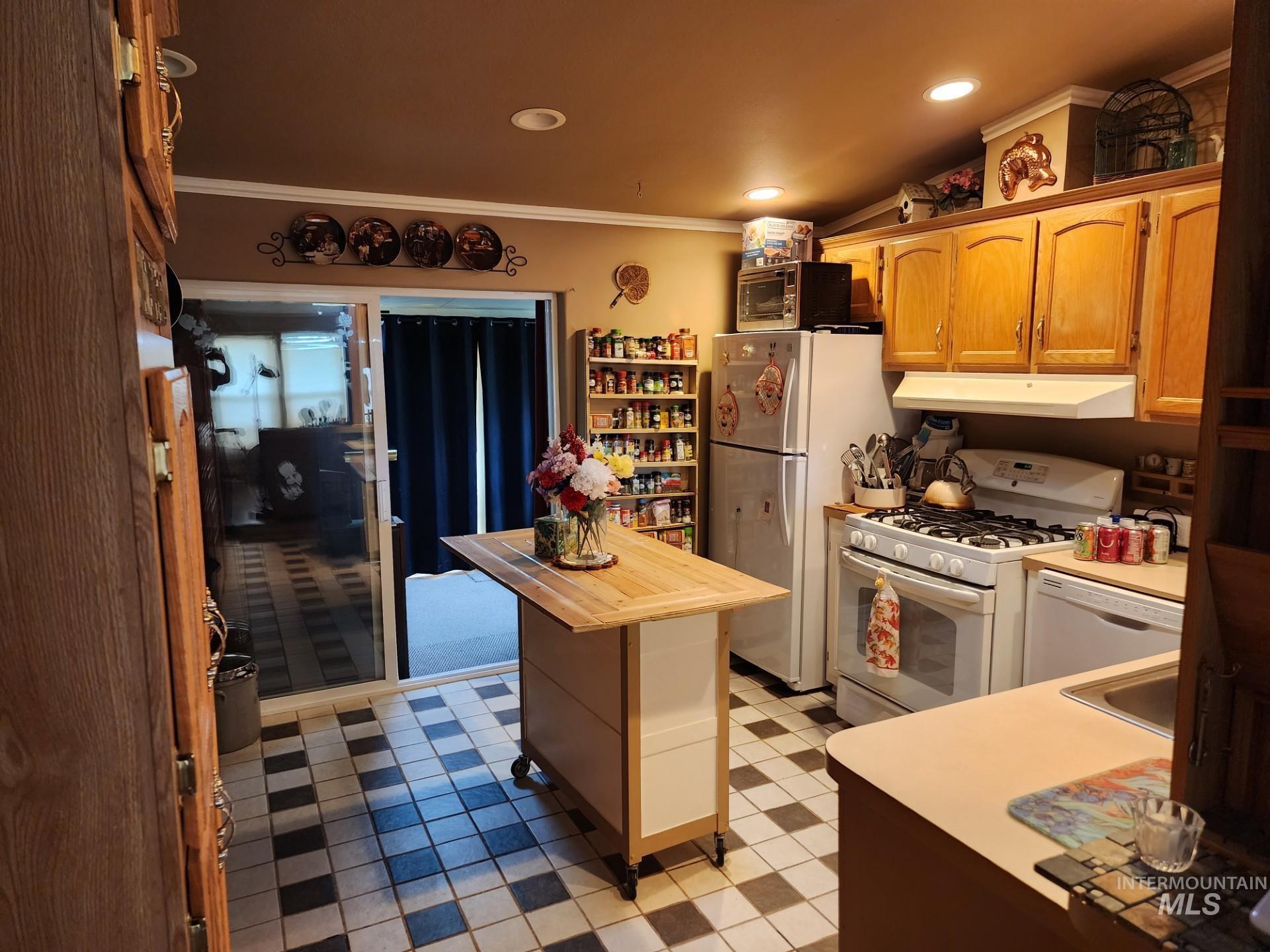 235 5th Street Grand View, ID 83624 - Photo 6 of 22 Expansive lawn area featuring a white picket fence, mature trees, and a built-in outdoor bench