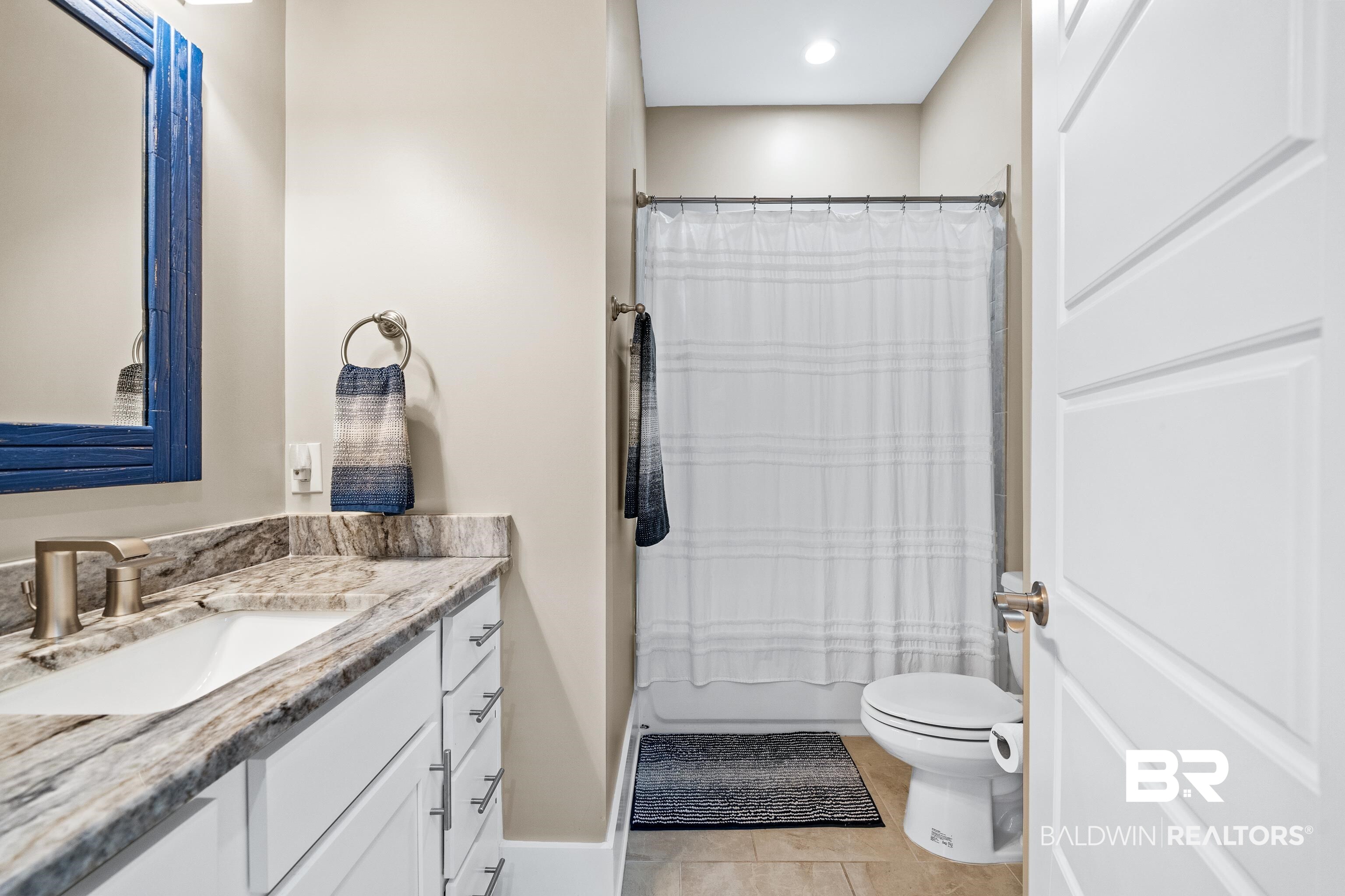 1018 Snapdragon Lane Foley, AL 36535 - Photo 11 of 37 Full bathroom featuring tile patterned flooring, vanity, shower / bath combo, and toilet