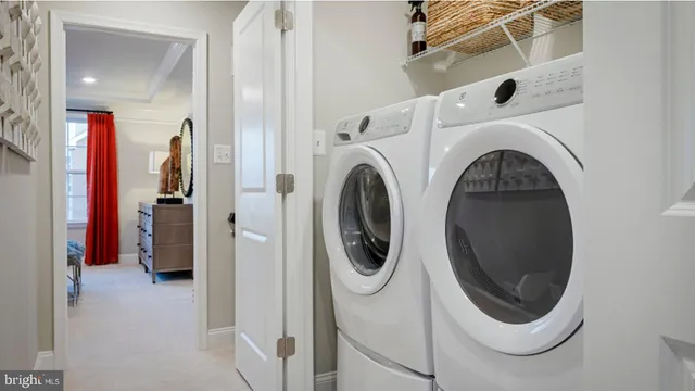 a view of a hallway with washer and dryer