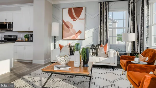 a living room with furniture and a painting on the wall