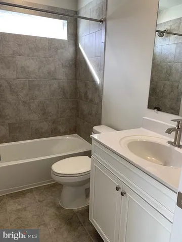 a bathroom with a sink a toilet and a bathtub
