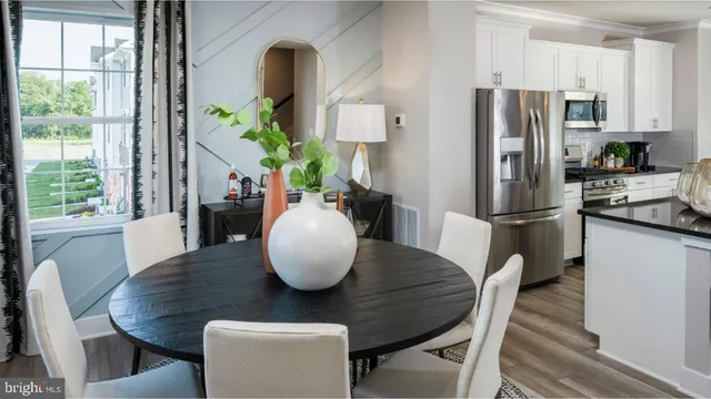 a view of a dining room with furniture window and wooden floor