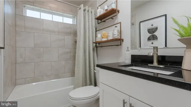 a bathroom with a sink a toilet and bathtub