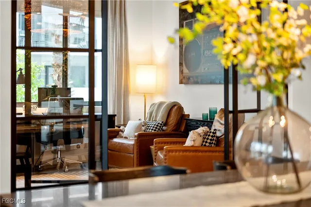 a living room with furniture and floor to ceiling window