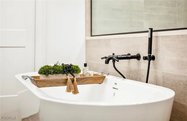 a white bath tub sitting in a bathroom