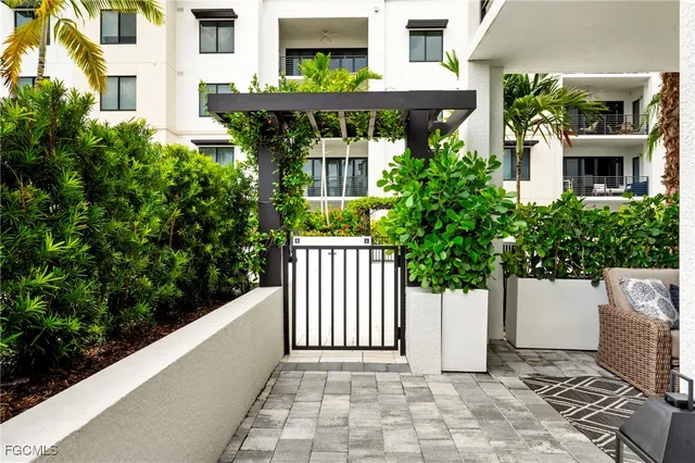 a view of a house with potted plants