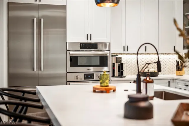 a kitchen with a sink and a stove top oven