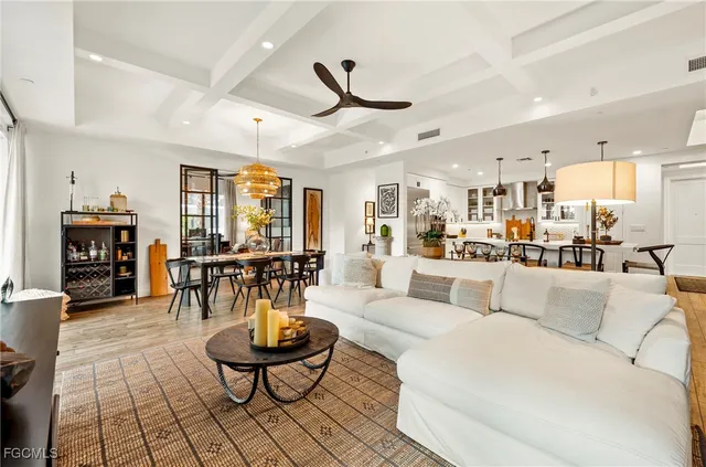a living room with furniture and kitchen view