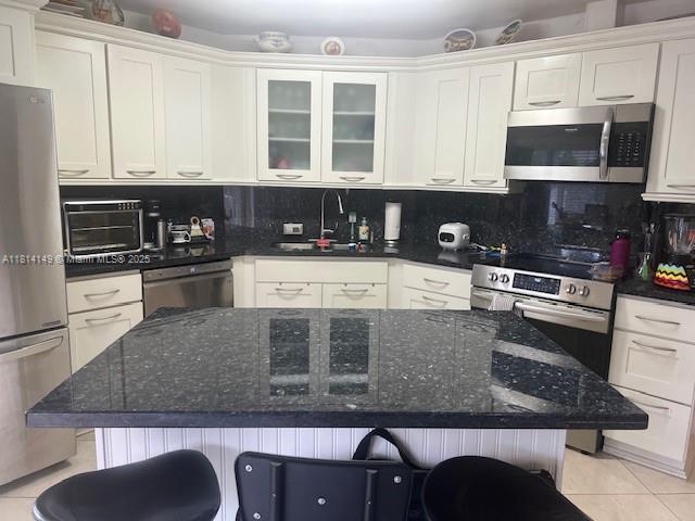 11861 Southwest 92nd Lane Miami, FL 33186 - Photo 14 of 33 a kitchen with stainless steel appliances granite countertop a stove a sink and a microwave