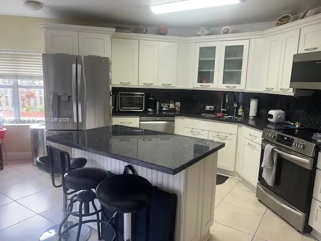 a kitchen with stainless steel appliances a sink counter space cabinets and a counter top space
