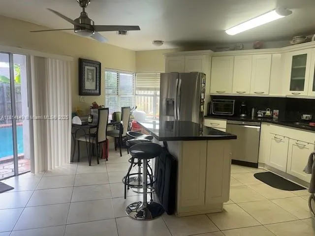 a dining room with furniture and a window