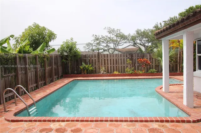 a view of a house with backyard porch and sitting area