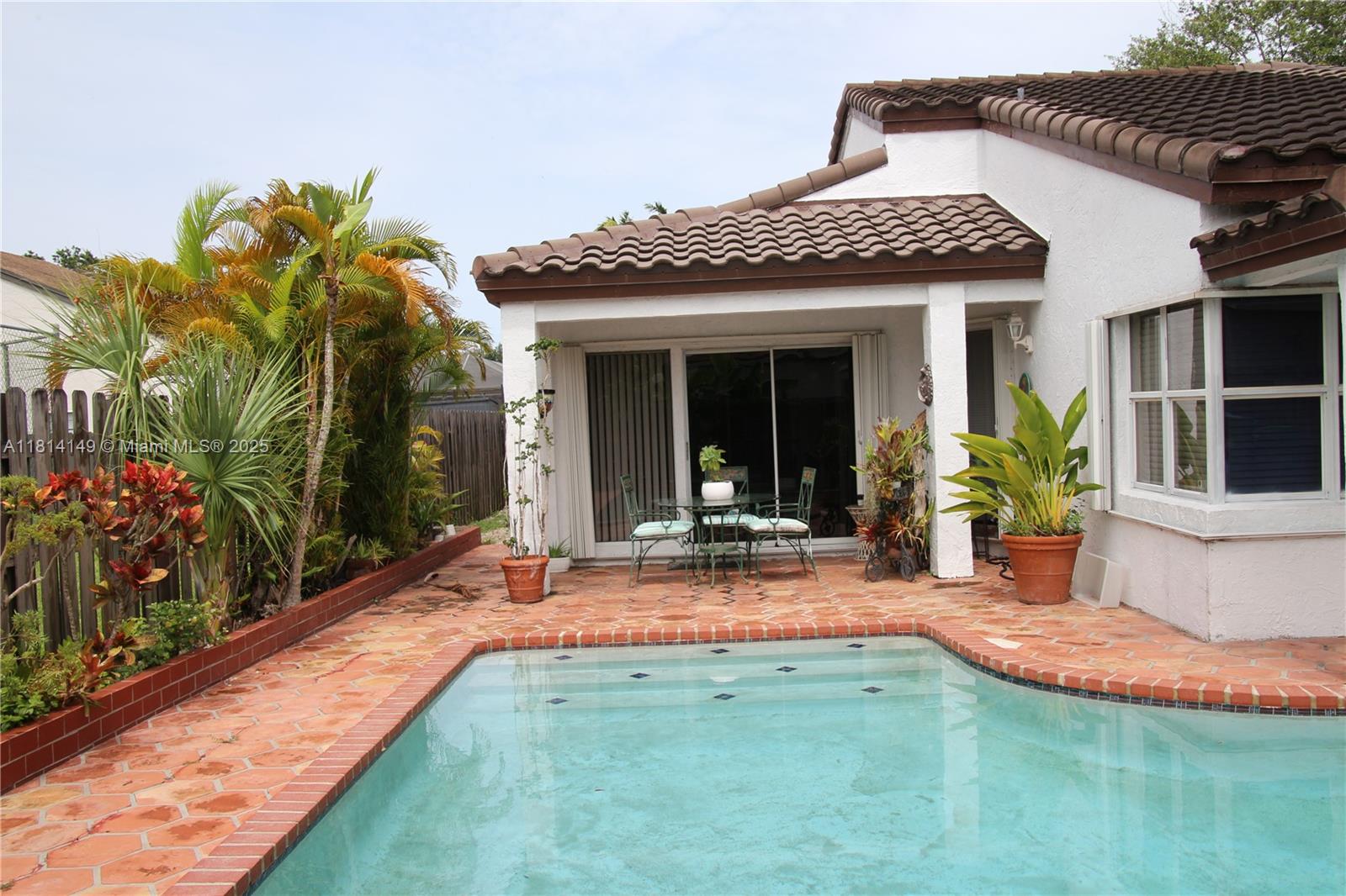 11861 Southwest 92nd Lane Miami, FL 33186 - Photo 20 of 33 a view of a house with potted plants and a yard in front of it