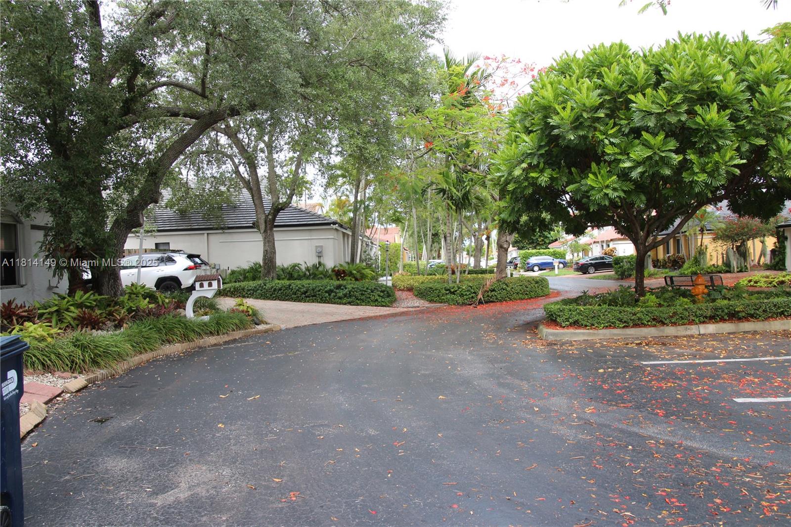 11861 Southwest 92nd Lane Miami, FL 33186 - Photo 29 of 33 a front view of a house with a yard and a garden