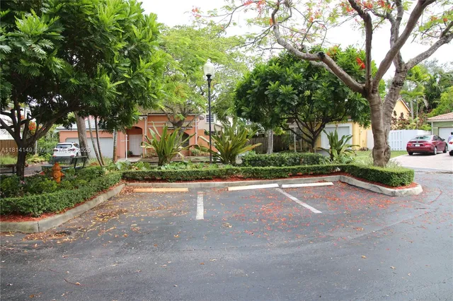 a view of a street with a cars parked on the road