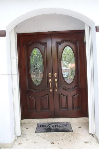 a dining room with furniture and chandelier