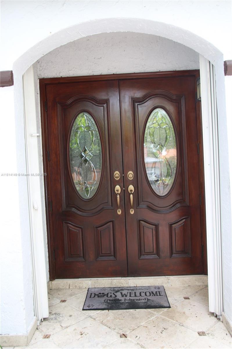 11861 Southwest 92nd Lane Miami, FL 33186 - Photo 4 of 33 a wooden door with a mirror
