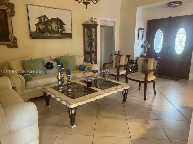 11861 Southwest 92nd Lane Miami, FL 33186 - Photo 6 of 33 a living room with couches a mirror and a dining table with wooden floor