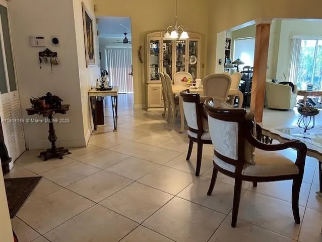 a view of a dining room with furniture and chandelier
