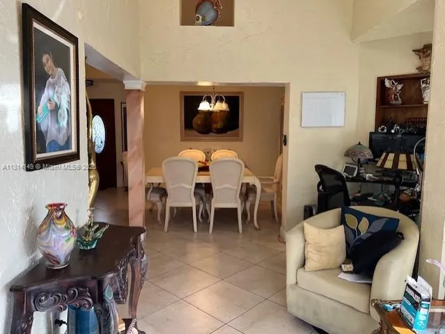 a living room with furniture and a floor to ceiling window
