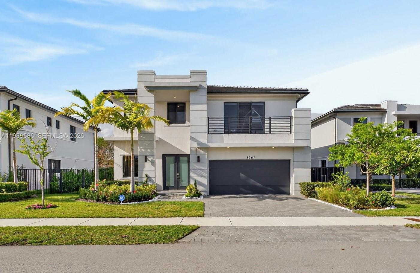 8267 Southwest 120th Terrace Miami, FL 33156 - Photo 1 of 61 a front view of a house with a yard and garage