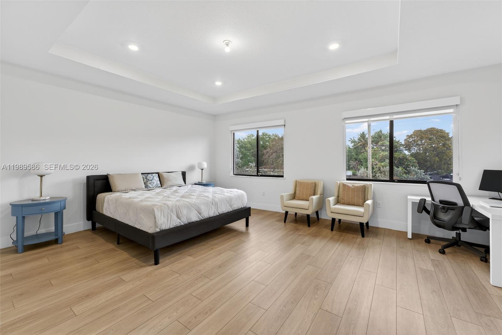 8267 Southwest 120th Terrace Miami, FL 33156 - Photo 20 of 61 a bedroom with a bed and large windows