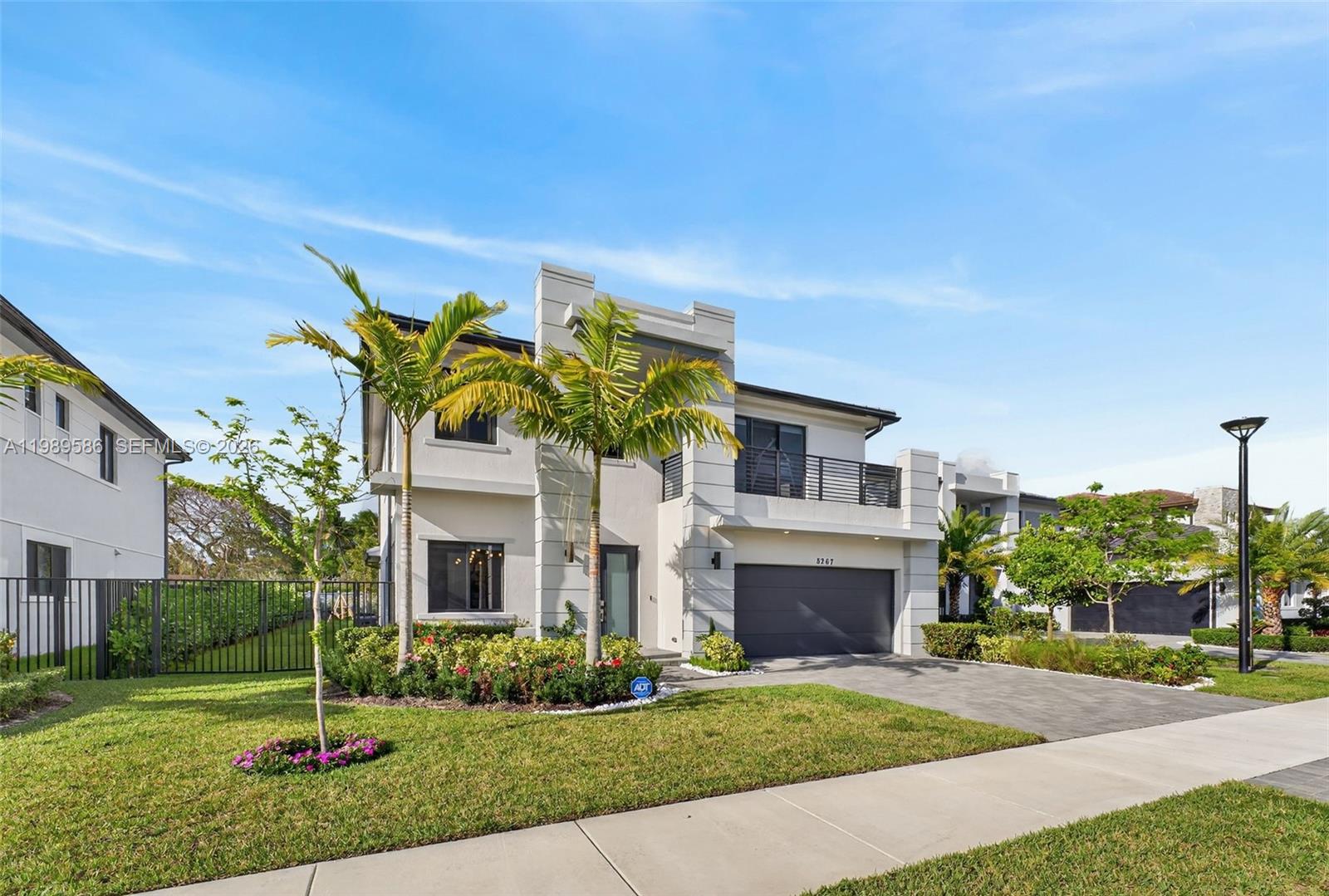 8267 Southwest 120th Terrace Miami, FL 33156 - Photo 2 of 61 a front view of a house with a garden and plants