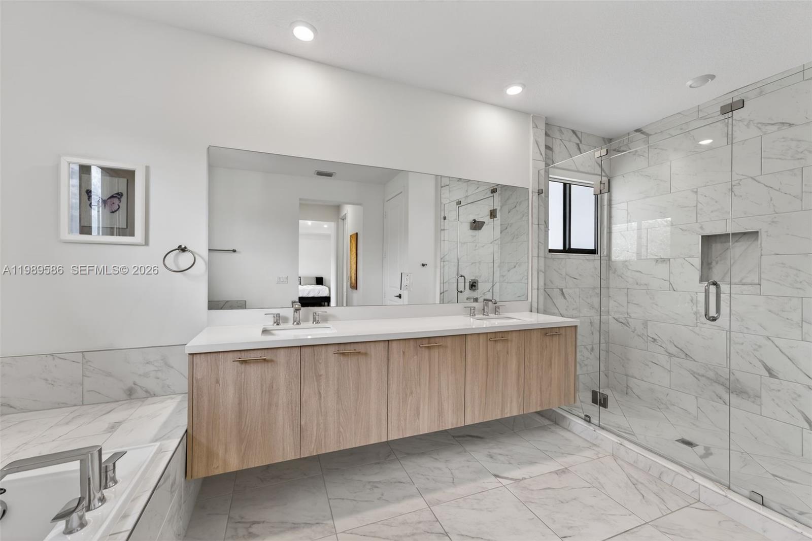 8267 Southwest 120th Terrace Miami, FL 33156 - Photo 25 of 61 a bathroom with a sink double vanity granite tub shower and a mirror