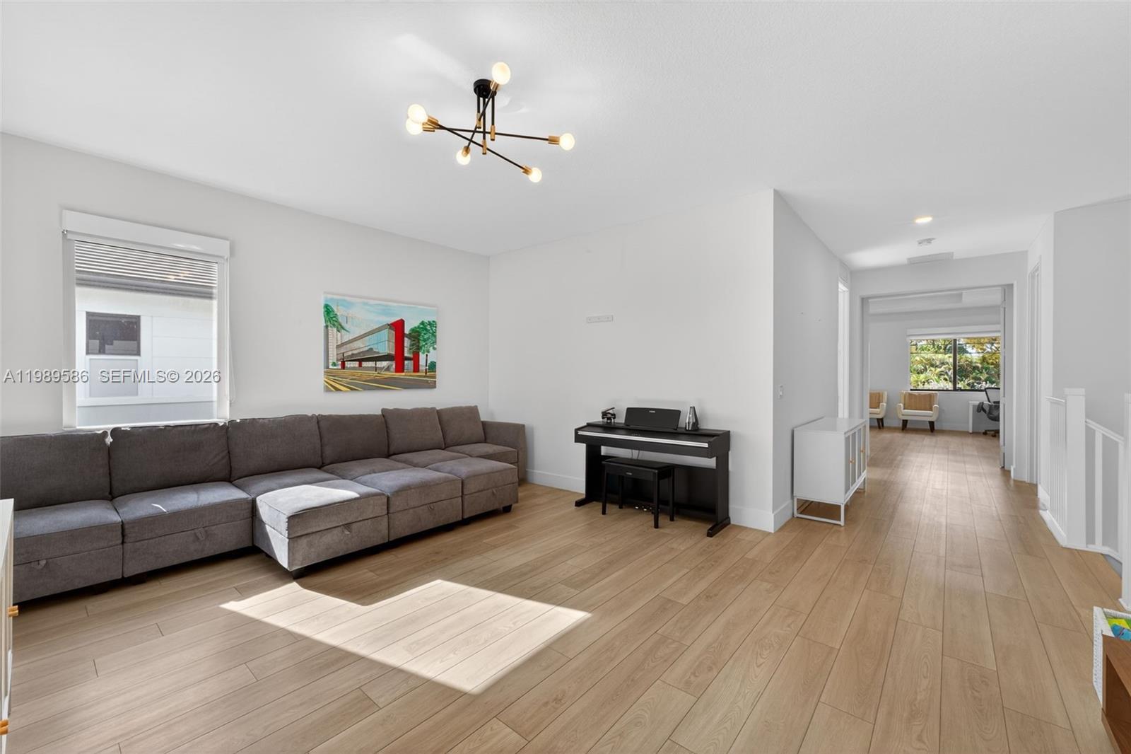 8267 Southwest 120th Terrace Miami, FL 33156 - Photo 27 of 61 a living room with furniture and a wooden floor