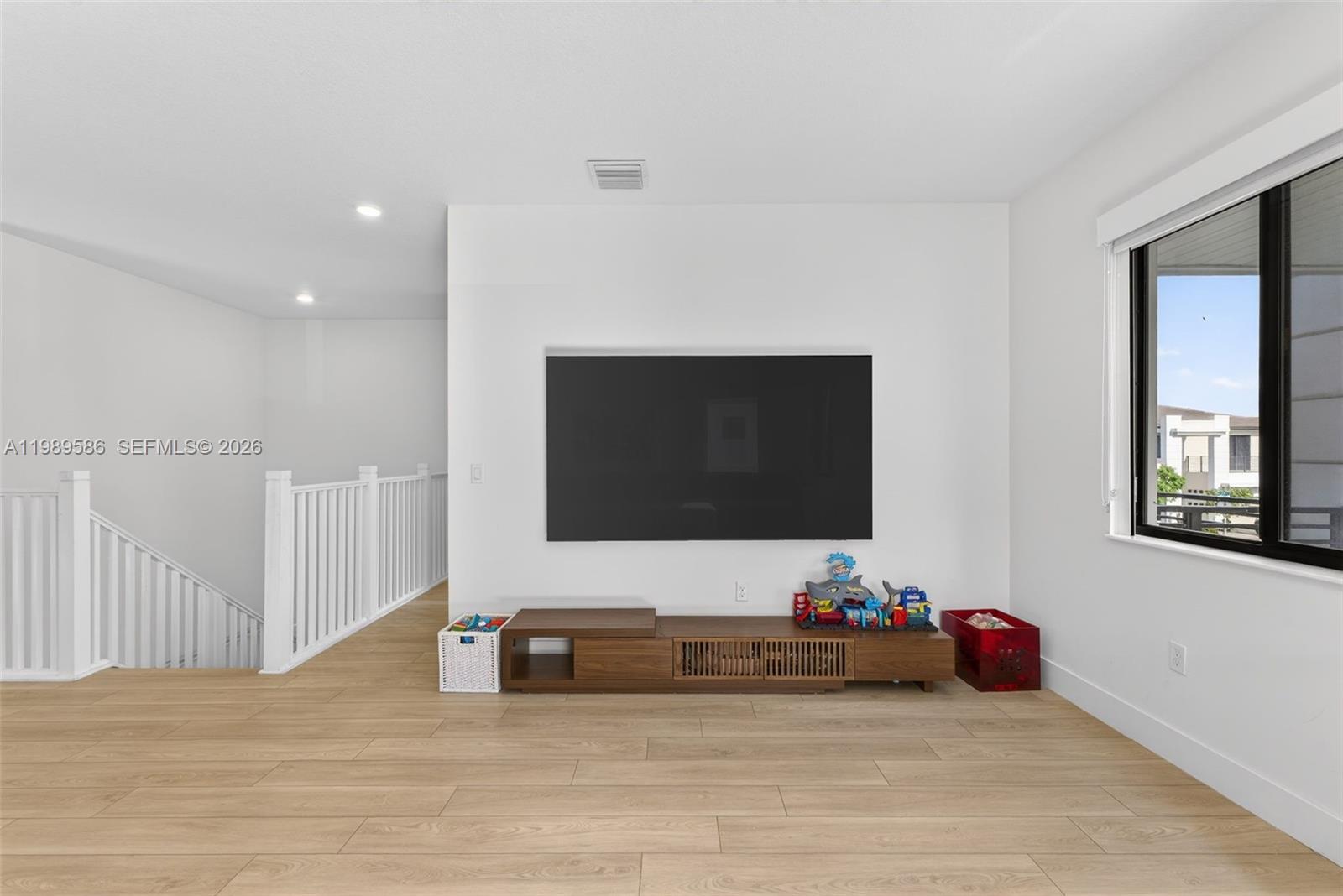 8267 Southwest 120th Terrace Miami, FL 33156 - Photo 28 of 61 a living room with furniture and a flat screen tv