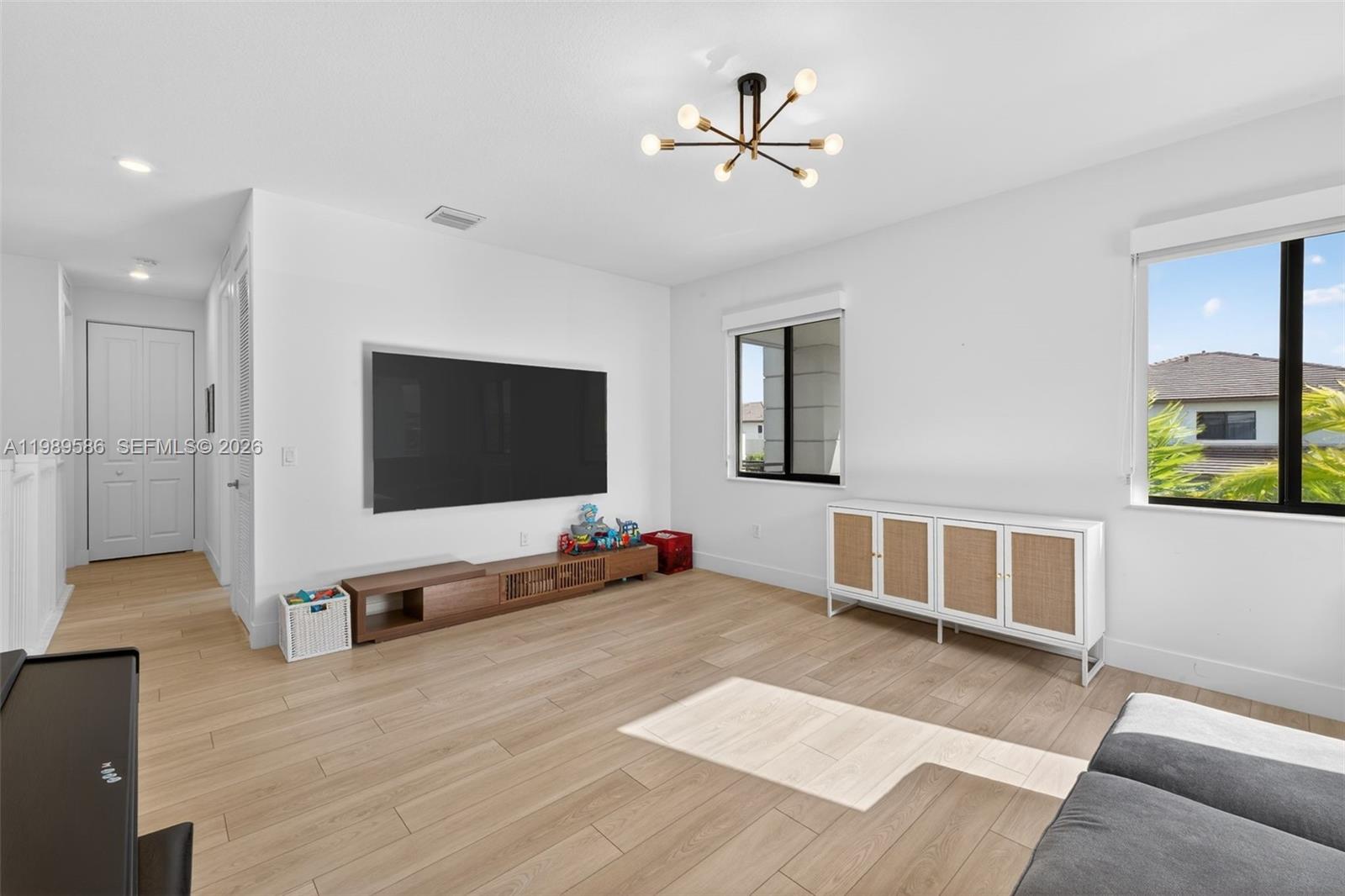 8267 Southwest 120th Terrace Miami, FL 33156 - Photo 29 of 61 a living room with furniture and a flat screen tv