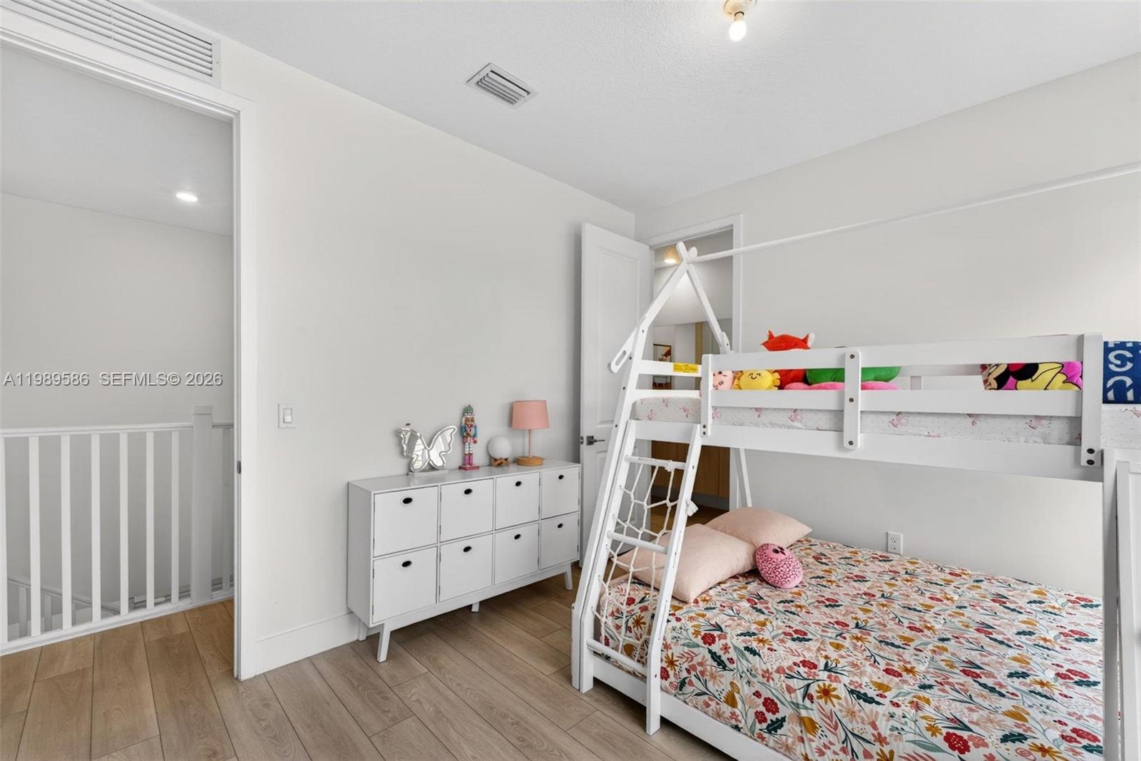 8267 Southwest 120th Terrace Miami, FL 33156 - Photo 31 of 61 a bedroom with baby toys and wooden floor