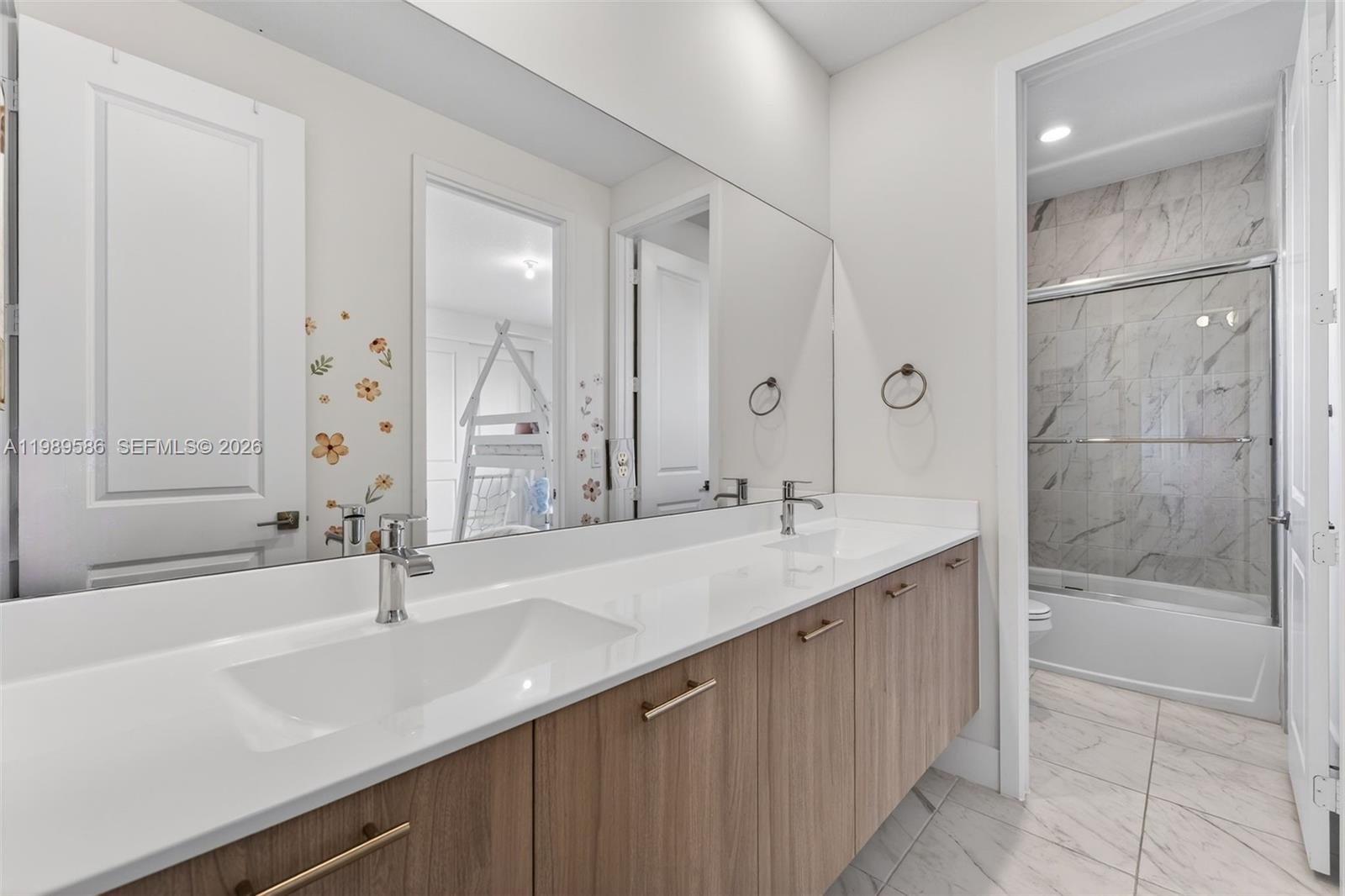 8267 Southwest 120th Terrace Miami, FL 33156 - Photo 36 of 61 a bathroom with a double vanity sink mirror and shower