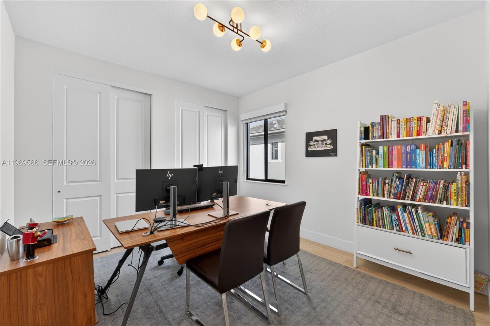 8267 Southwest 120th Terrace Miami, FL 33156 - Photo 38 of 61 a view of a workspace with a bookshelf