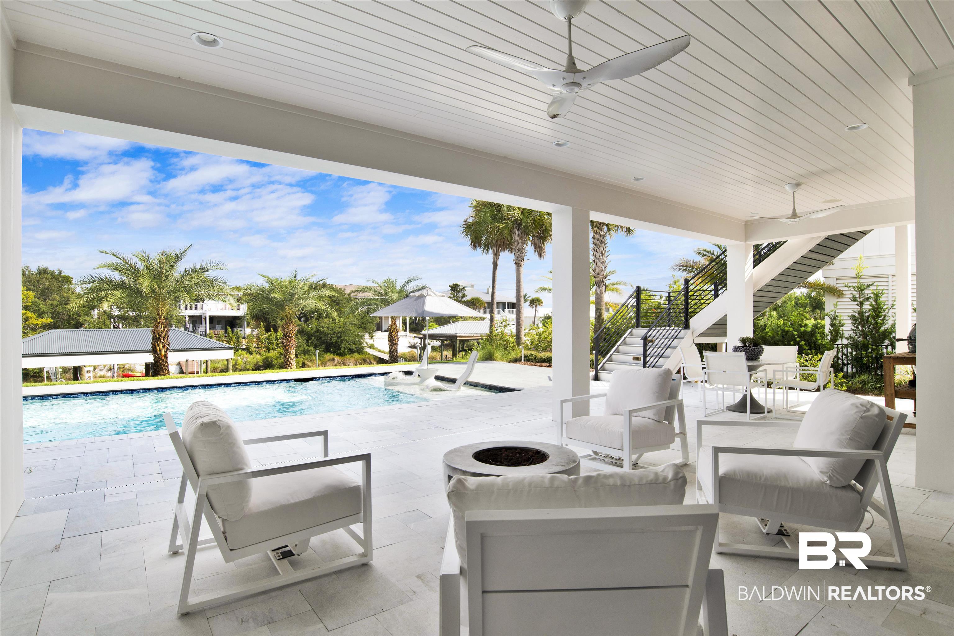 30239 Canal Court Orange Beach, AL 36561 - Photo 57 of 70 View of patio / terrace featuring ceiling fan, an outdoor pool, stairway, and an outdoor living space with a fire pit