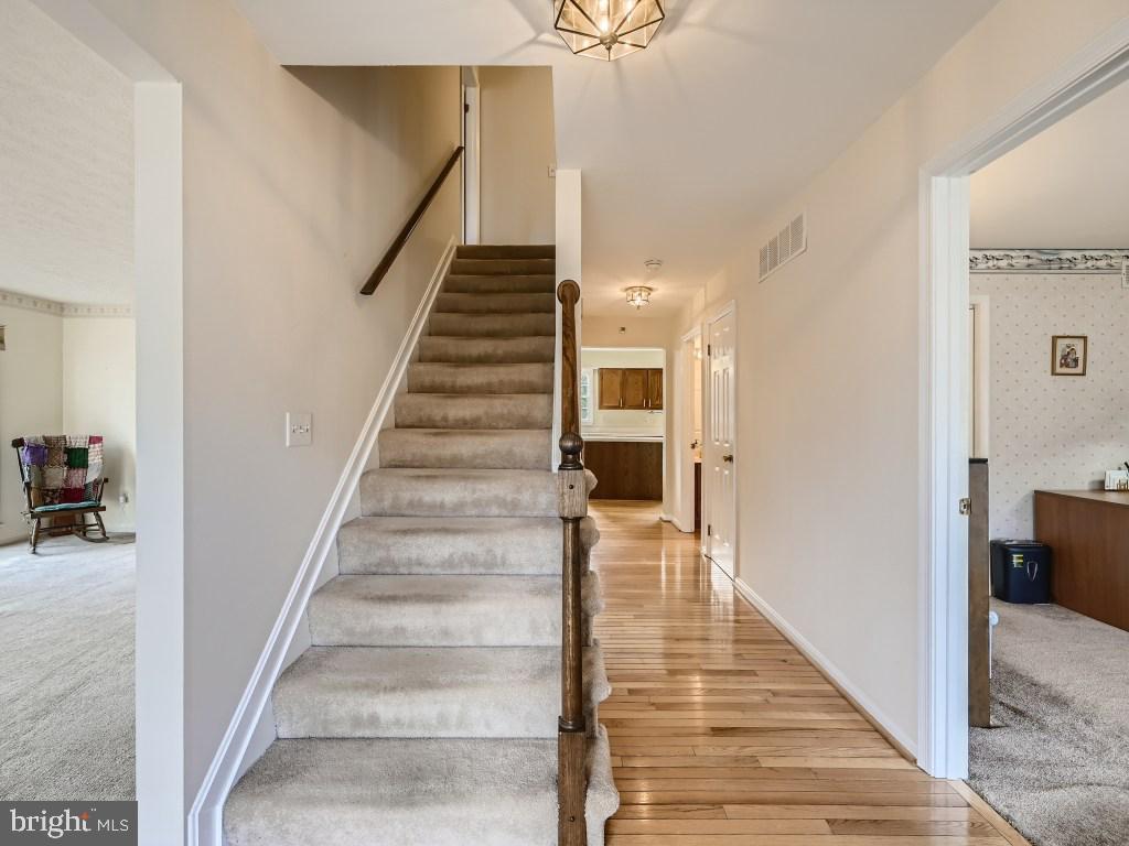 7904 Poplar Grove Road Severn, MD 21144 - Photo 6 of 33 Hardwood Floors in Main Floor Hallway